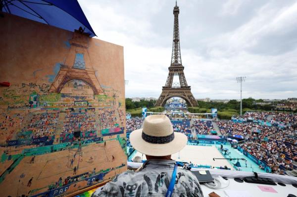 General view of the Eiffel Tower Stadium shows Peter Spens painting an image of the stadium and the game as the Eiffel Tower and the Olympic rings are seen in the background. — Photo: Reuters